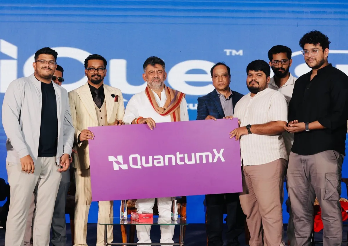 The QuantumX team on stage holding the QuantumX banner at the official launch of QuantumX in Bengaluru