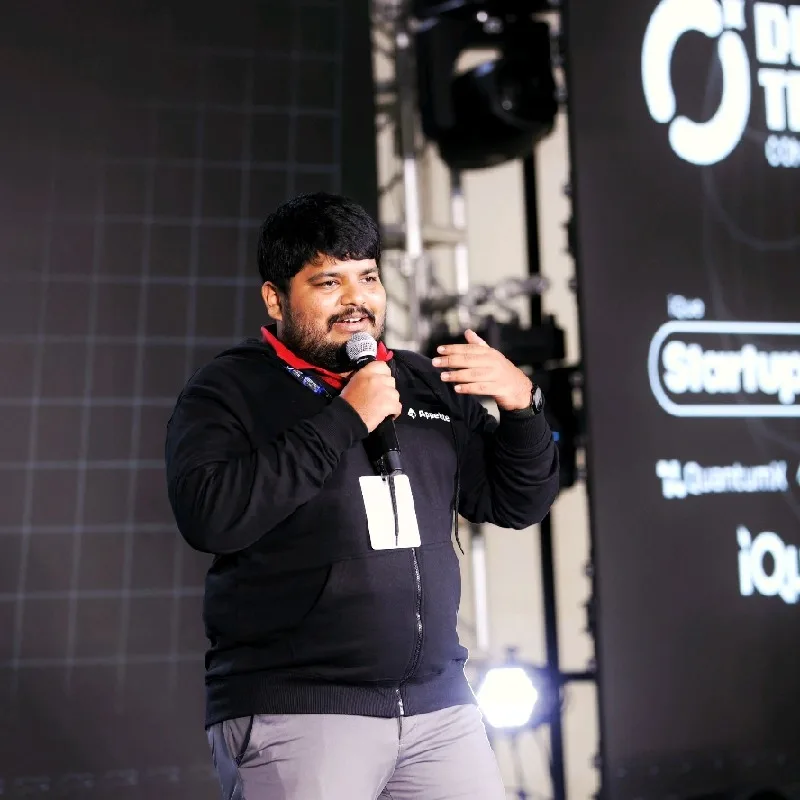 Portrait of Ajmal Ibn Mohammed Althaf speaking on stage
